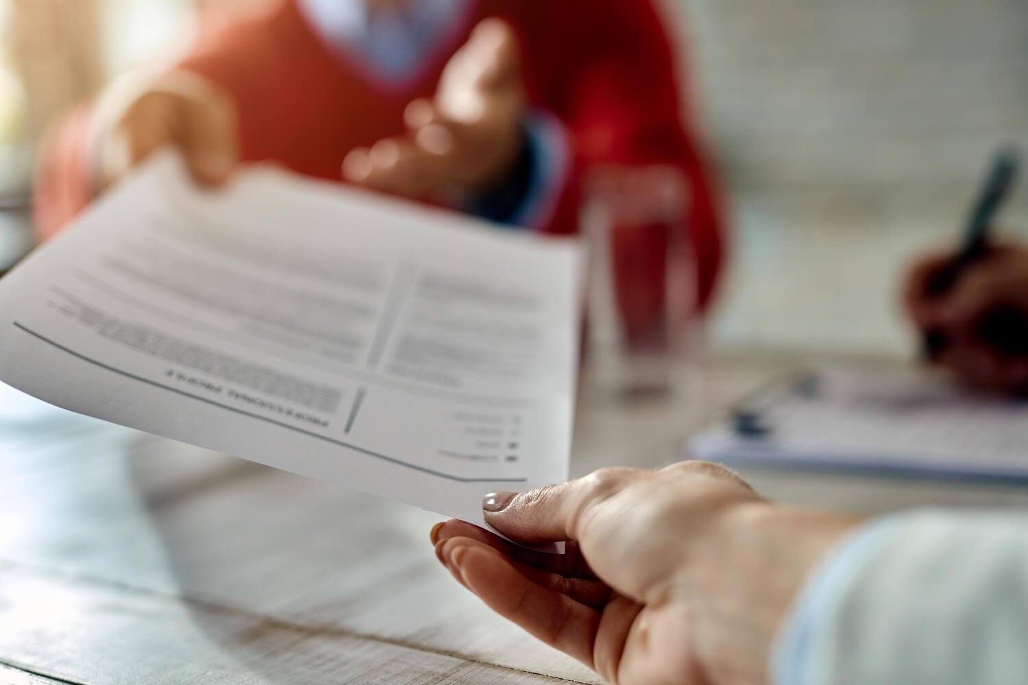 Close-up-of-hands-holding-a-resume-while-searching-job