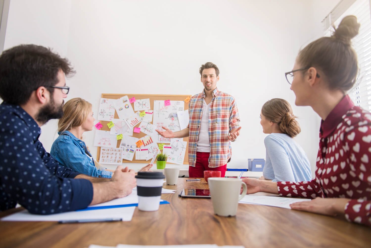 Group-brainstorming-ideas-with-sticky-notes-in-a-collaborative-environment