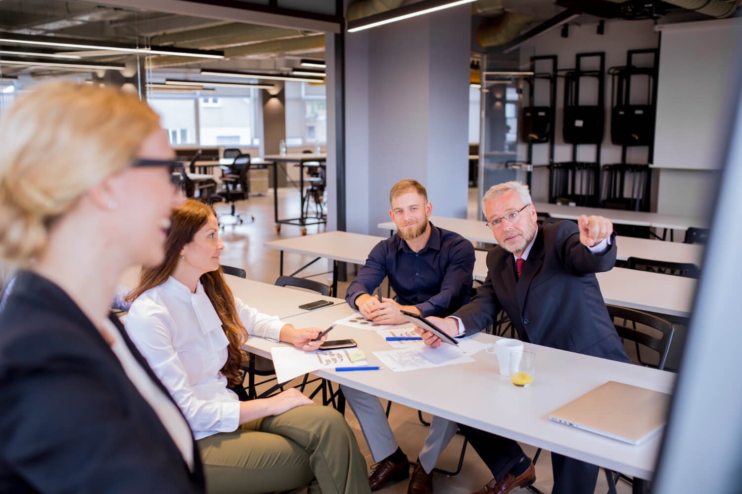 Manager-leading-a-diverse-team-meeting-in-a-modern-office-setting