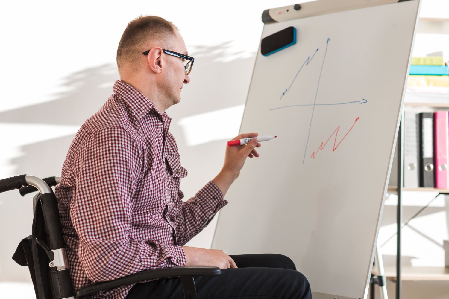 Person-reviewing-professional-achievements-on-a-whiteboard